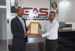 Mr Bonsa Bayissa, Director, EAS-Ethiopia hands the ISO 15189:2012 accreditation certificate to Dr Solan Bekele, CEO, Metu Karl Hospital